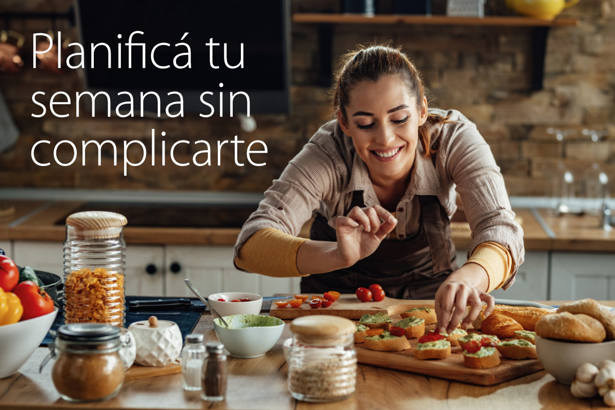 Happy woman enjoying while preparing bruschetta in the kitchen.